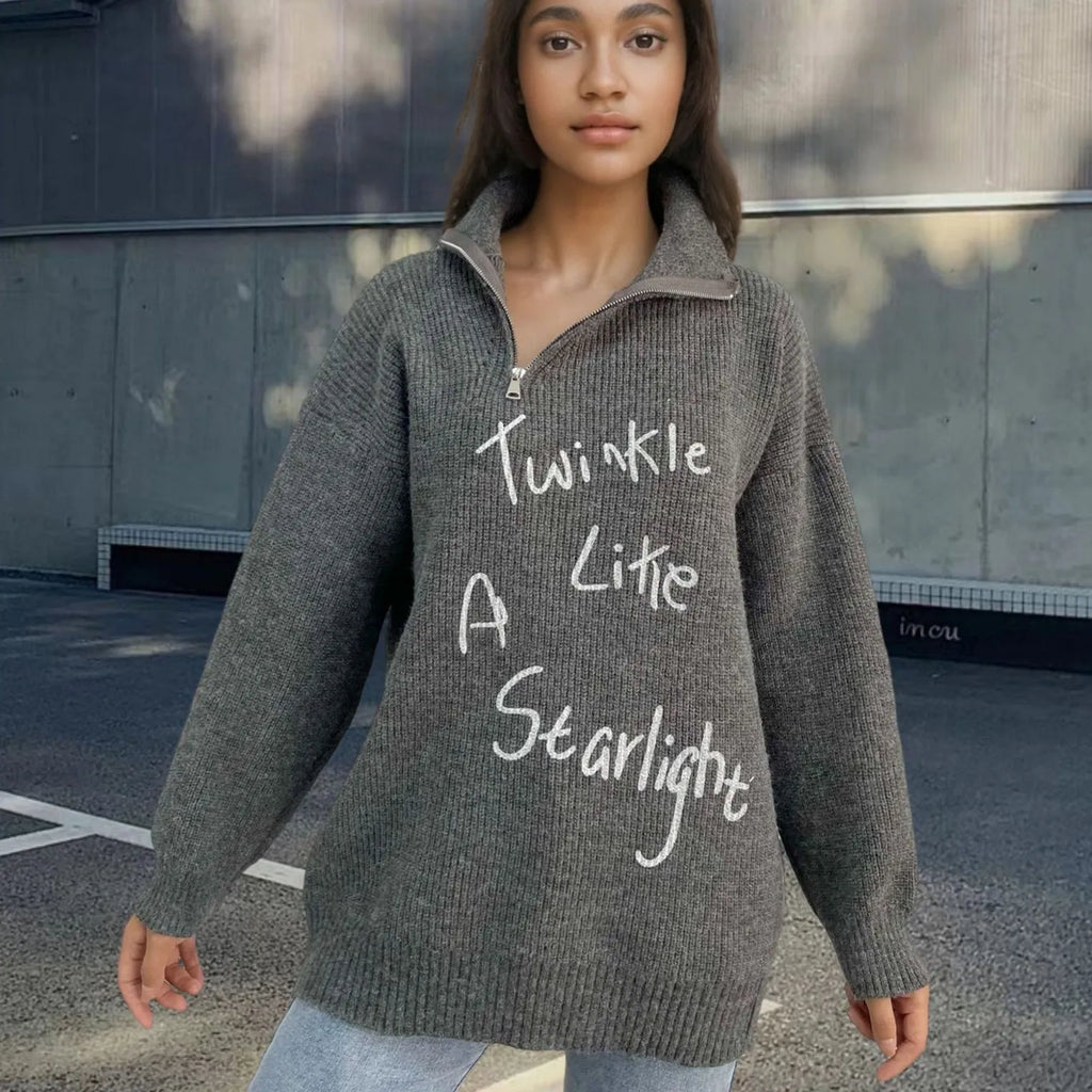 Woman wearing a light khaki alpaca wool pullover sweater with loose lapels, a turtleneck, and an oblique zipper.