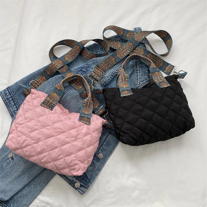 A soft oxford cloth shoulder messenger bag in a horizontal square shape with a single strap.