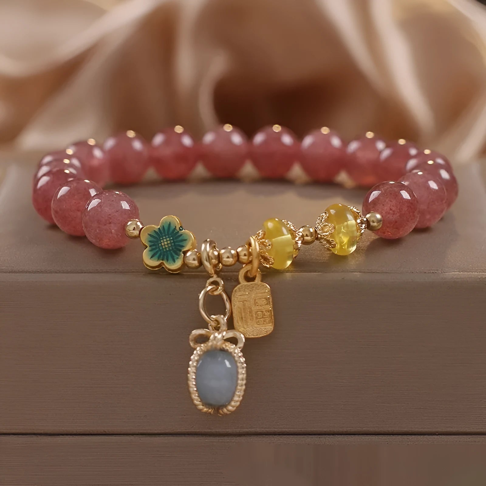 Red strawberry quartz beaded bracelet with alloy setting and rhinestone decoration