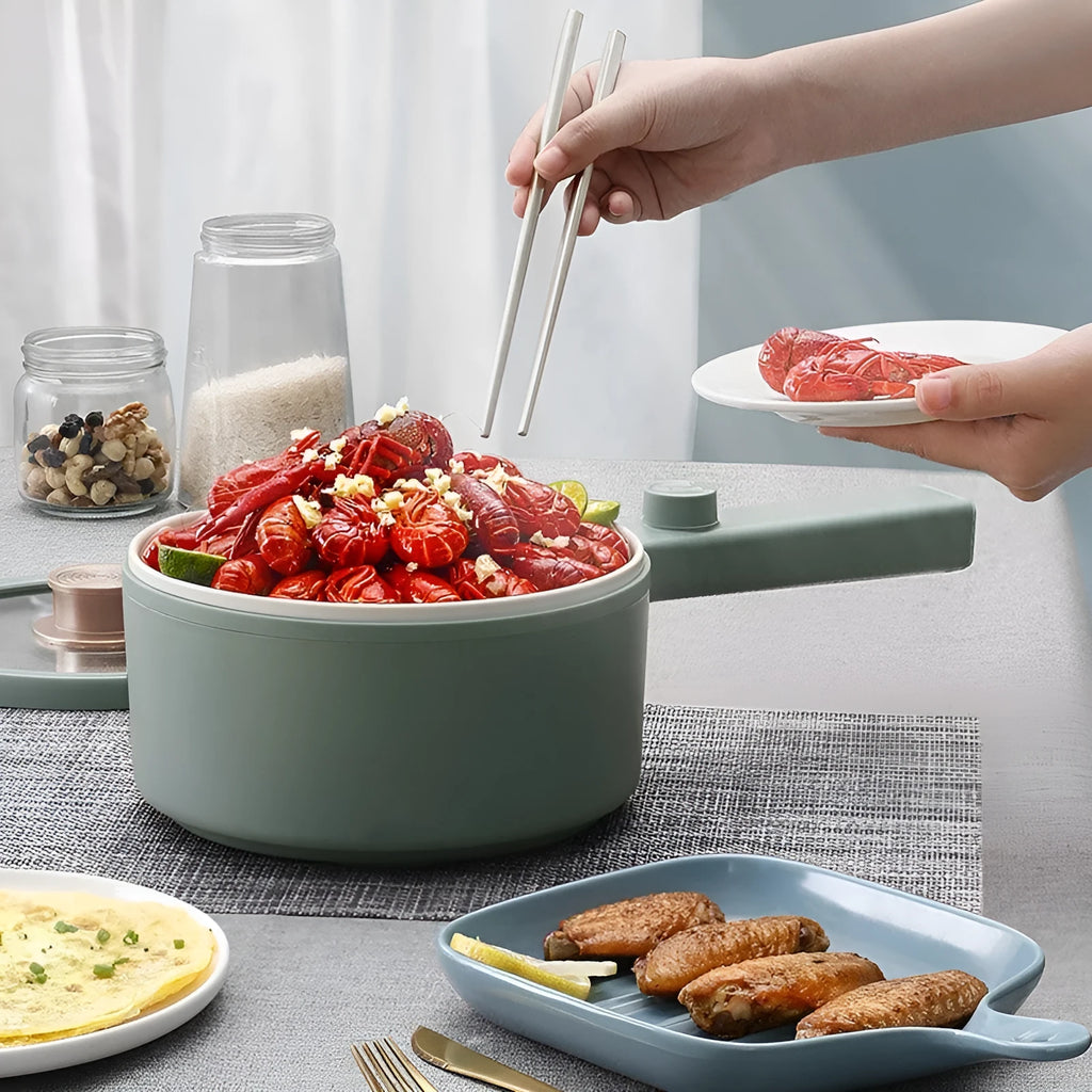 White or green portable electric hot pot cooker with multi-function controls on a countertop.