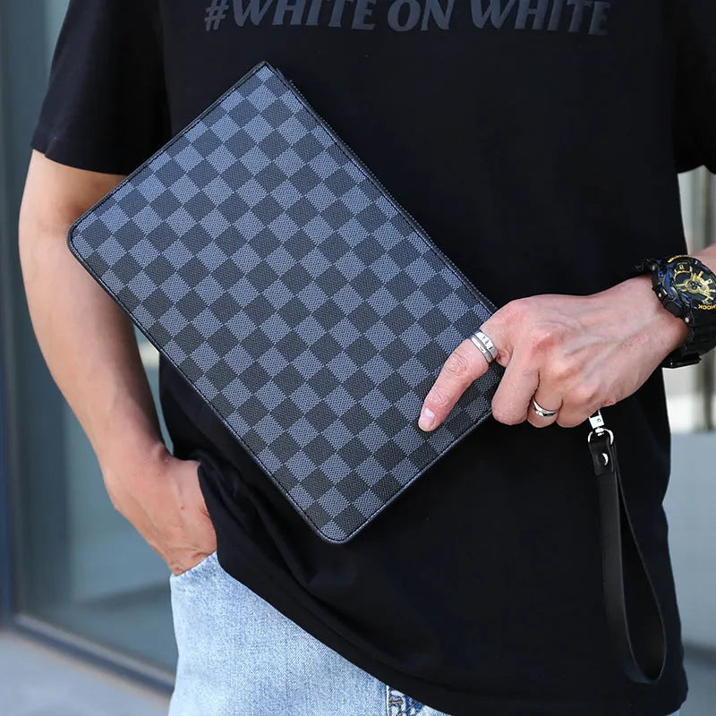 Men's black PU leather clutch with six card slots, measuring 18cm by 28cm, on a table