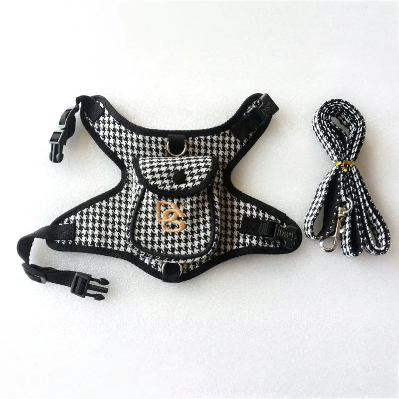 Black houndstooth cotton vest for a small dog, showing the leash attachment strap on the back.