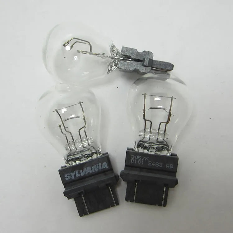 Wagner automotive brake light bulb with yellow glass and 16mm metal socket