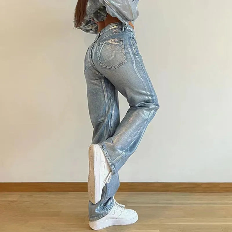 High waisted straight leg blue denim jeans with contrast stitching on a model.