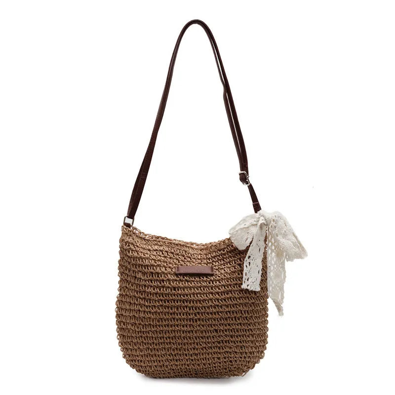 Women's woven straw messenger bag with hollowed design in khaki colour showing vertical square shape and single shoulder strap