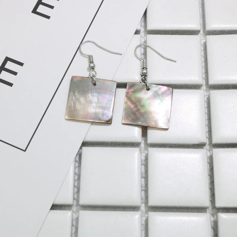 Women's geometric shell earrings in square and rectangular designs with natural shell material texture