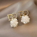 White DO letter embroidered ball earrings for women, trendy drop style with letter and ball detail.