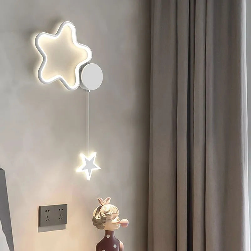 Five-pointed star shaped children's bedside wall lamp with cloud and star motifs in black finish
