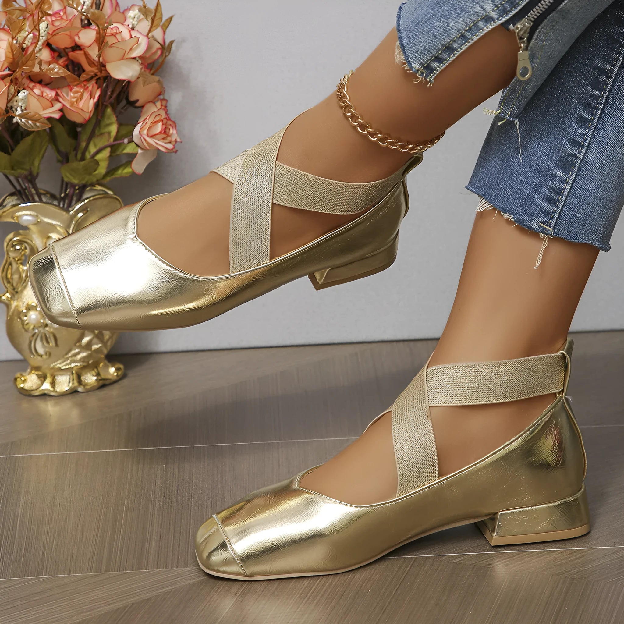 Gold slip-on evening pump with square toe and low rubber heel on a white background