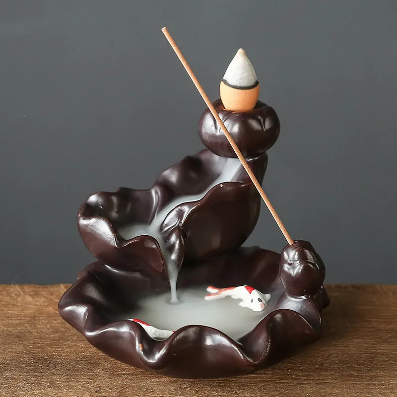 Modern ceramic backflow incense burner with sandal ornament in green tree design.