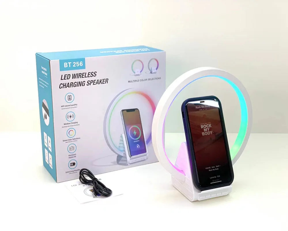 White rectangular 15W wireless charging pad with integrated Bluetooth speaker and ambience light.