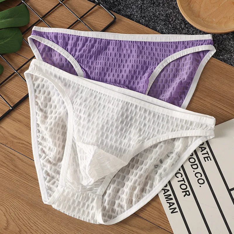 Men's low waist transparent lace underwear in white on a mannequin, showing the breathable fabric texture.
