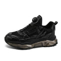 Men's black rotating button dad shoes with mesh upper and non-slip sole on wooden surface