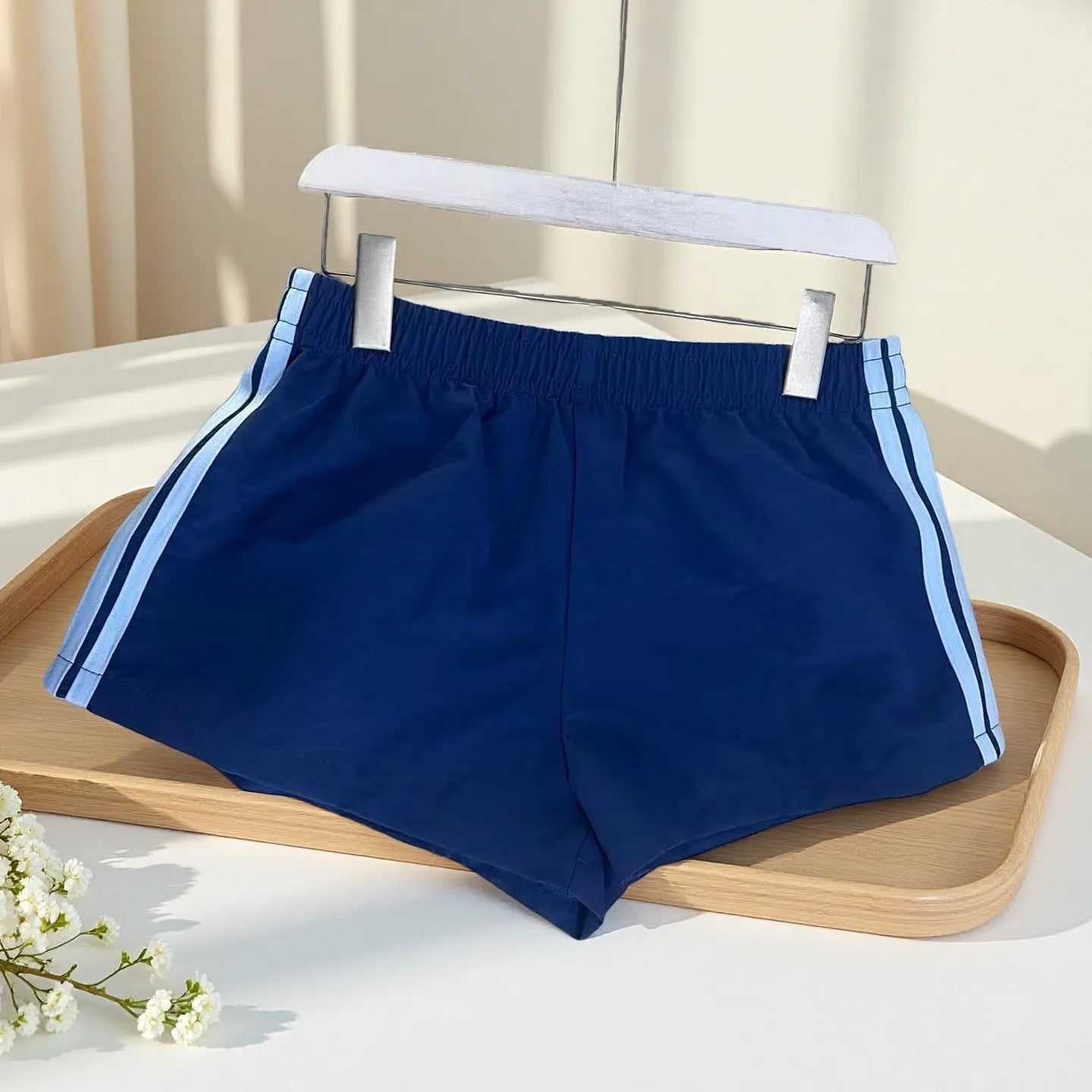 Navy blue men's high-waist nylon sports shorts on a white background