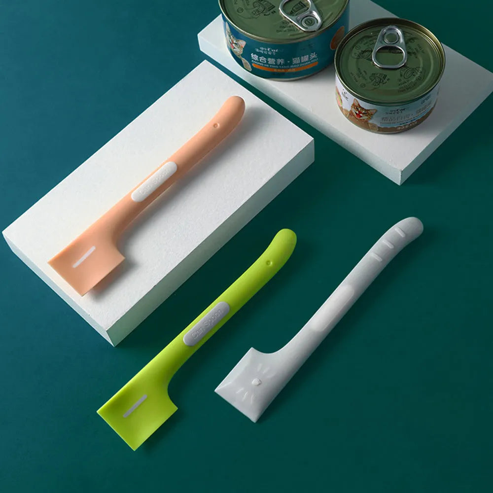 Green pet feeding spoon with 16cm handle scraping canned food from jar