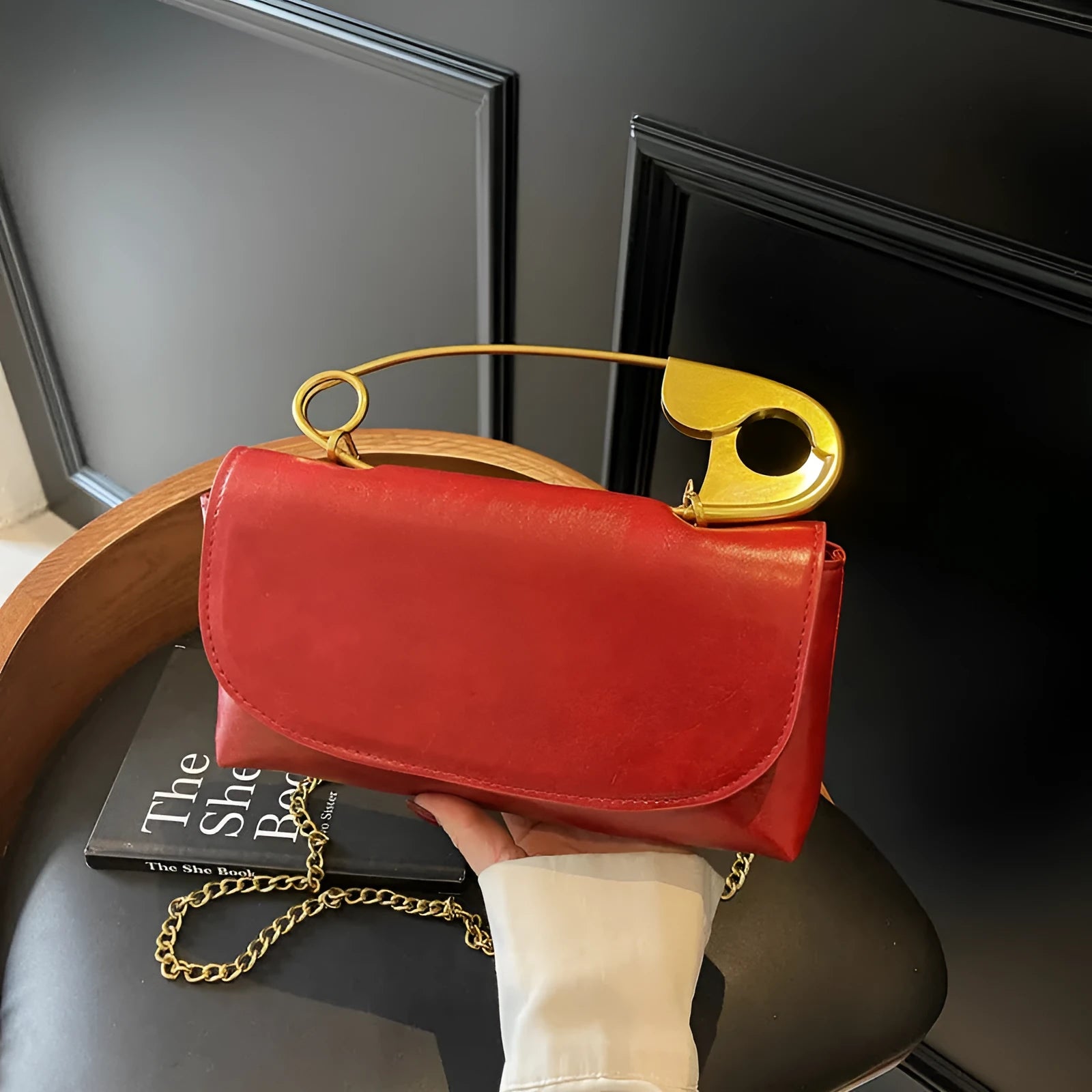 Black street trend shoulder handbag with sandwich pockets and visible sewing thread details.