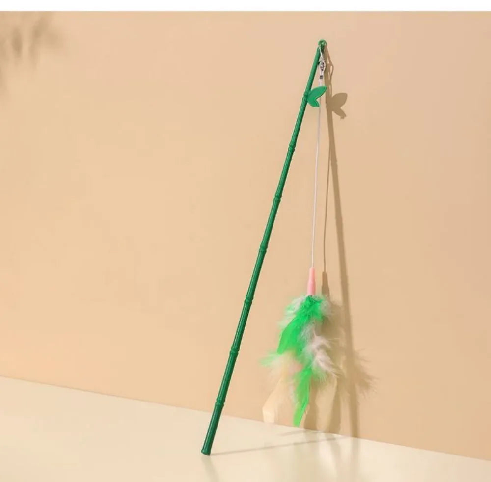 Green interactive cat wand toy with feather and bell attachments for stimulating play