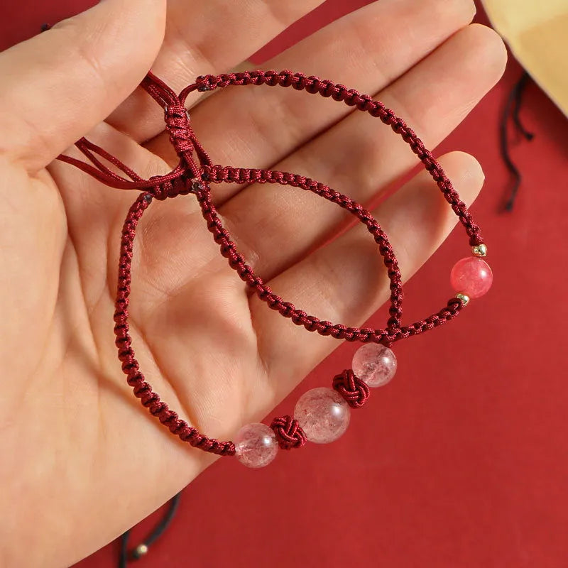 Woven red rope bracelet with spherical strawberry quartz beads and alloy clasp