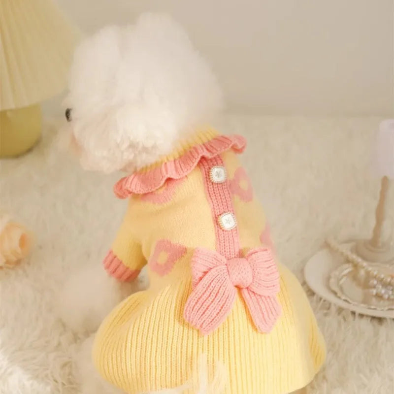 Yellow acrylic dog sweater on a small puppy, showing a casual knitted design.