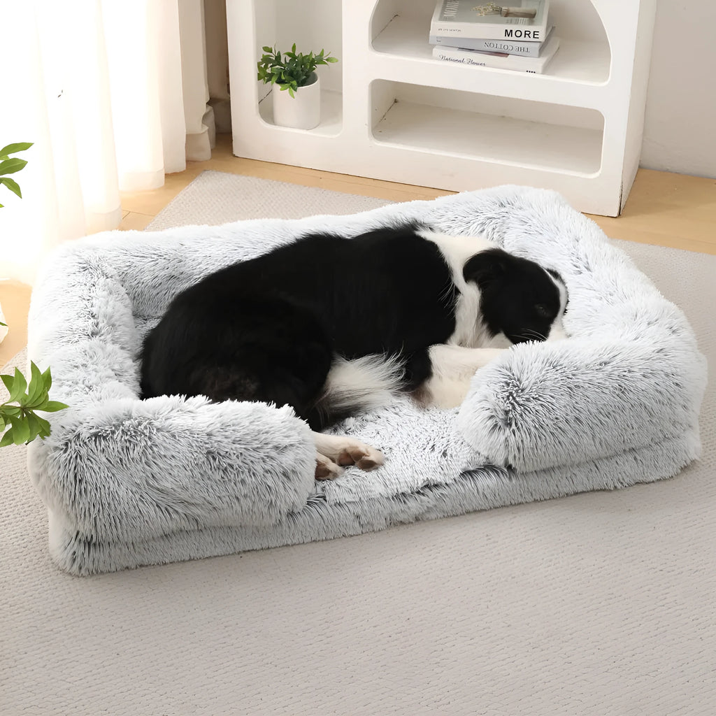 Plush round dog bed in beige brown with raised sides and a removable inner sleeve.