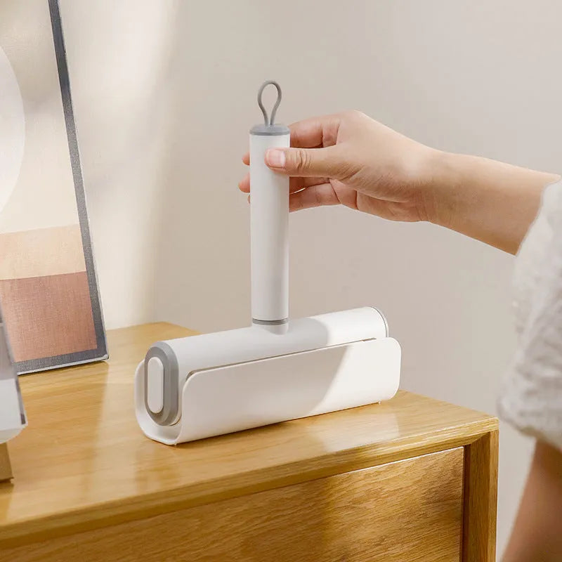 Lint removal roller tool for pet hair with tearable paper sticks on handle