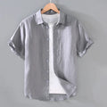 Men's grey linen short-sleeved casual shirt with a regular fit and cardigan style on a hanger