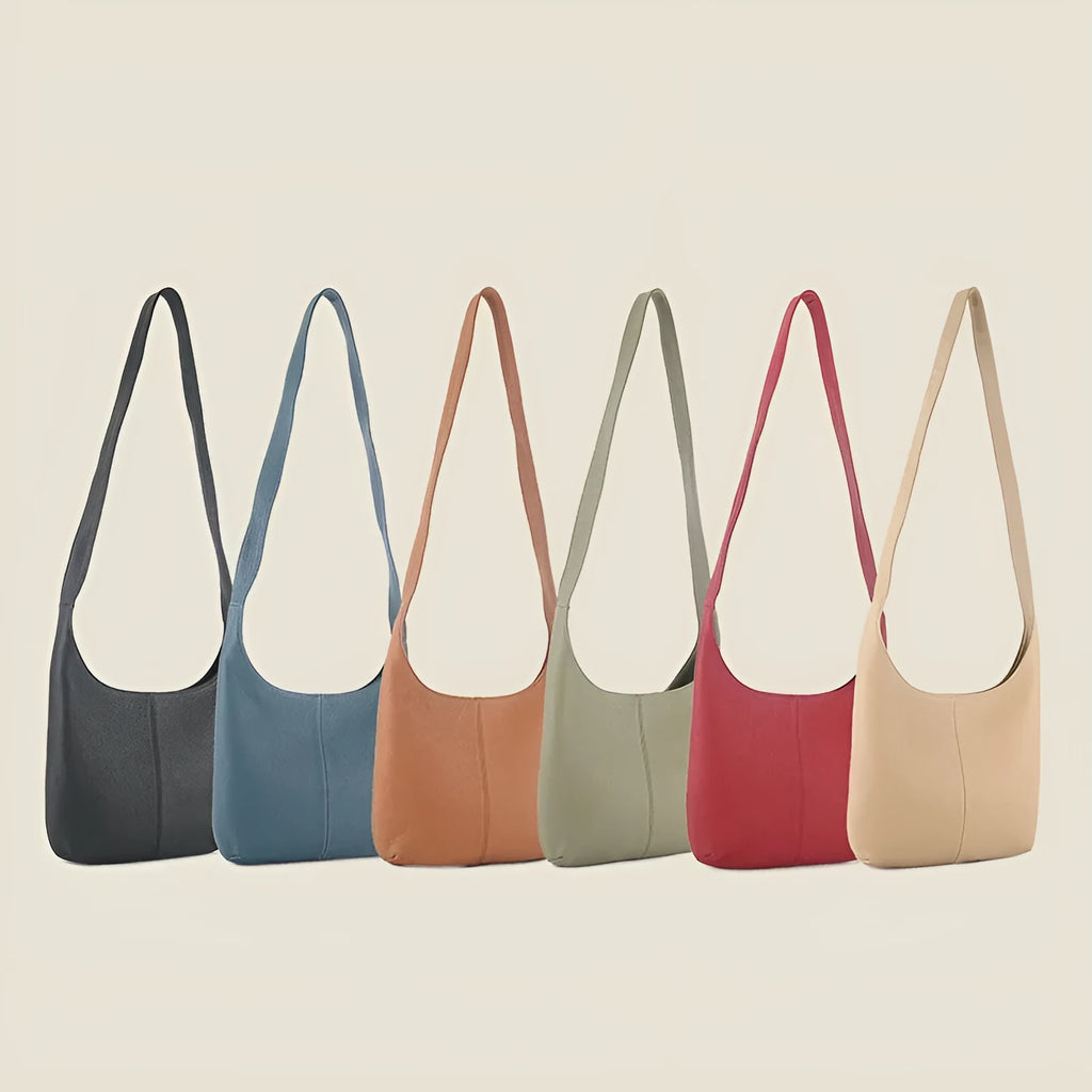 Leather women's casual zip crossbody bag in top grain genuine leather with canvas lining and open outer pocket.