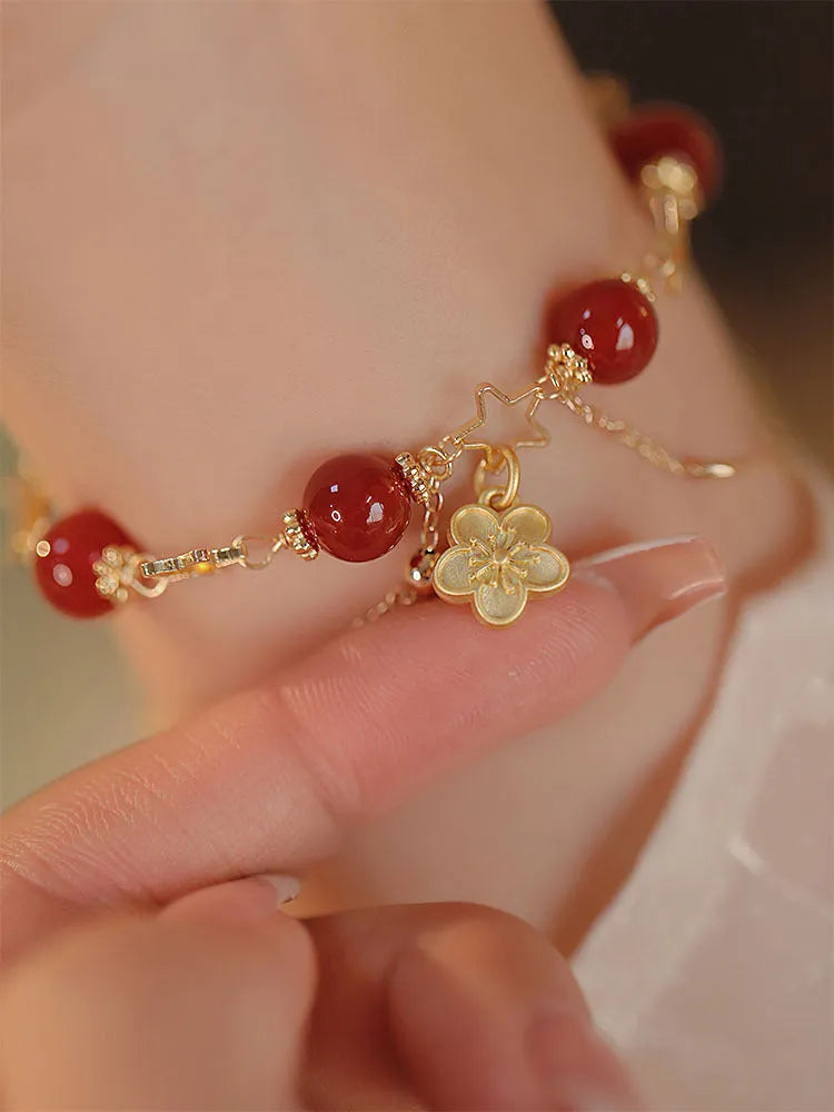 Women's red agate double layer bracelet with floral motifs and adjustable sliding knot closure