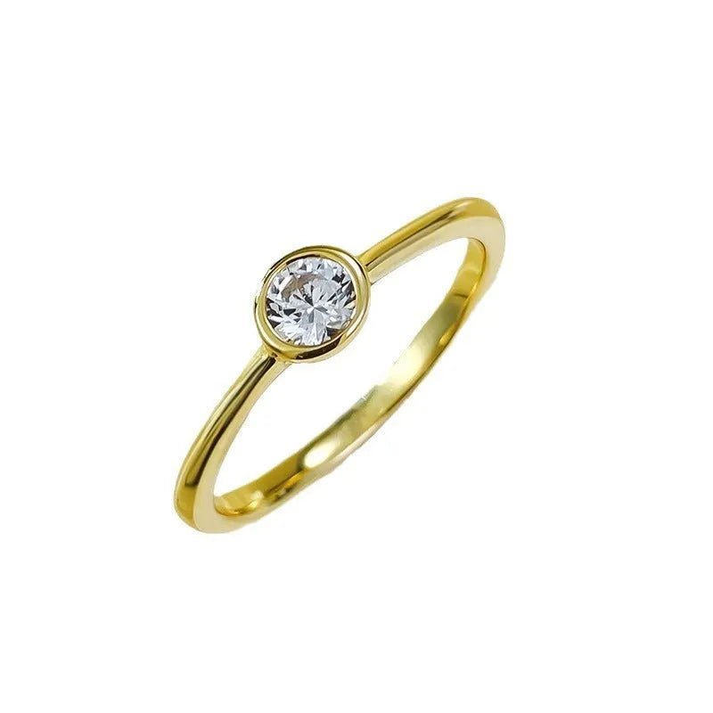 Minimalist silver crown ring with linear design details in R962 gold or platinum finish on a grey background.