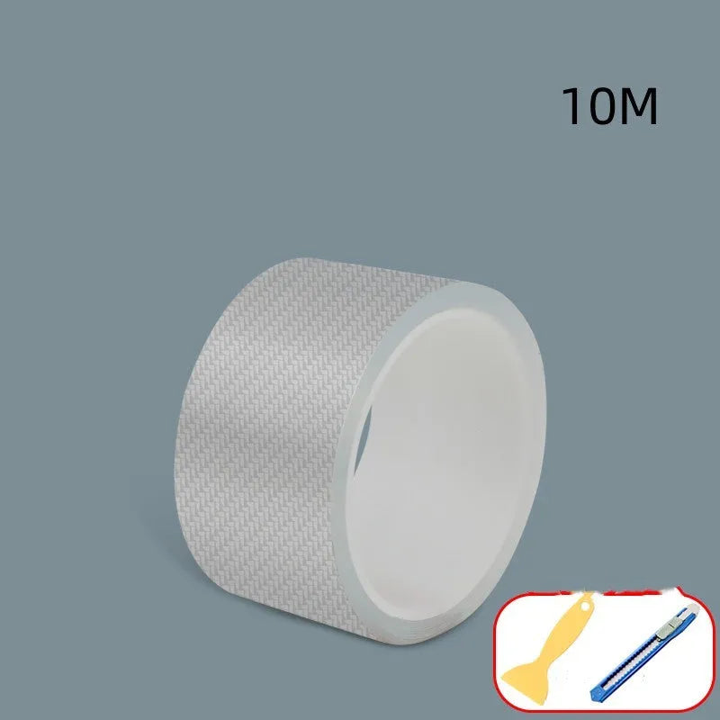 Roll of transparent carbon fibre grain anti-collision strip for car protection with scraper and utility knife.