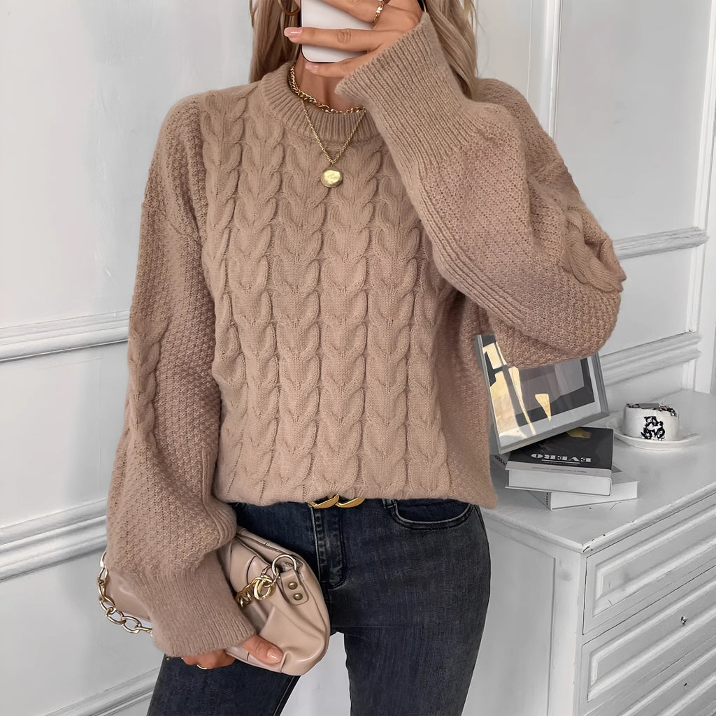 Beige women's loose round neck casual pullover sweater with textured thread detail on a hanger.