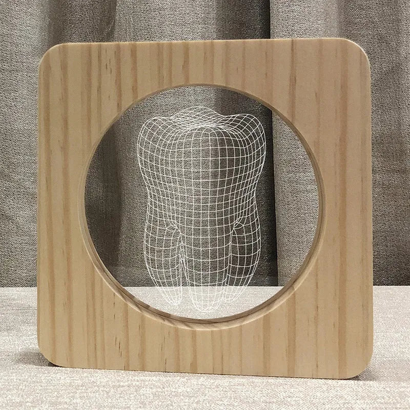 Tooth-shaped wood colour night lamp with USB cable on wooden surface