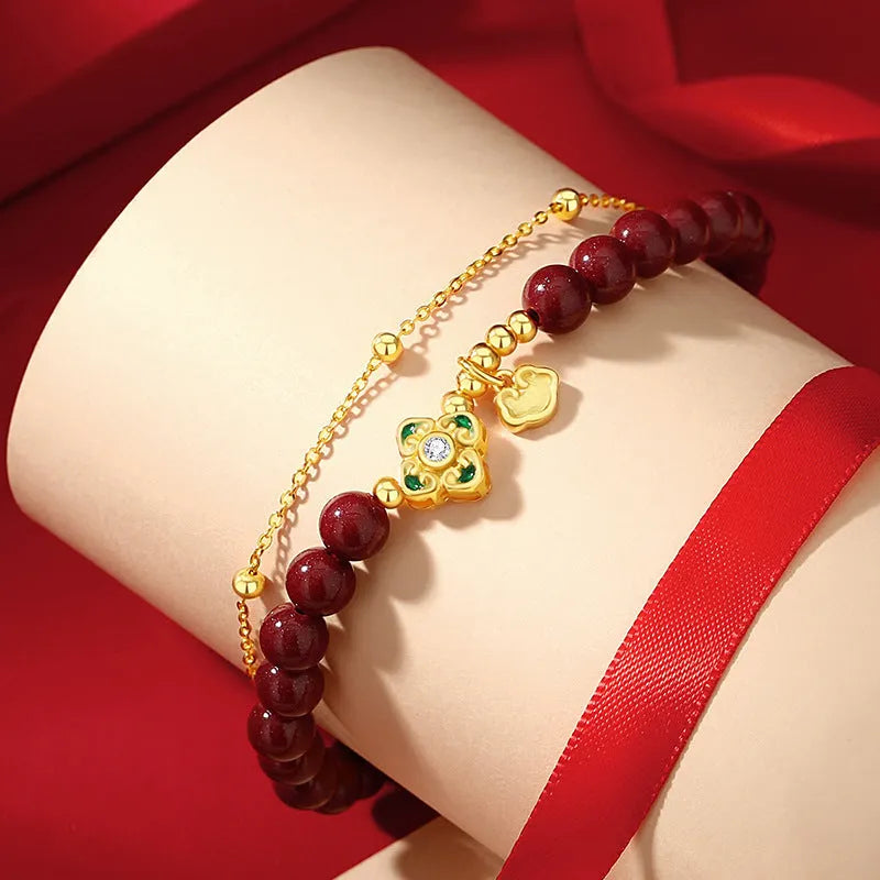 Women's geometric sterling silver bracelet with Ruyi, Xiangyun and red cinnabar flower detailing.