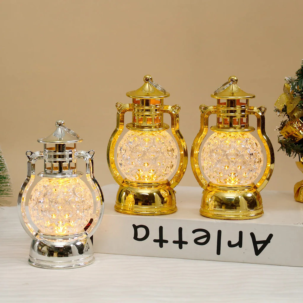 Creative retro-style small oil lamp LED night light in gold or silver finish on a table.