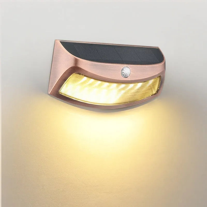 Solar outdoor wall lamp with smiling face design measuring 153x76x38mm for garden lighting
