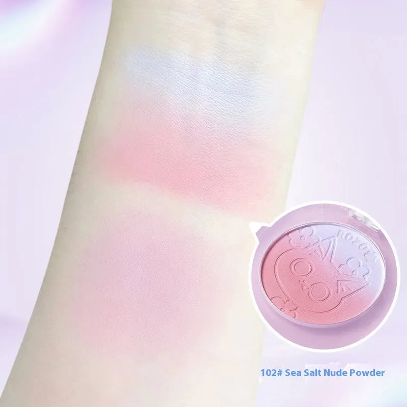 Two-tone gradient matte blusher plate for cheeks in a compact, shown with optional application brush.