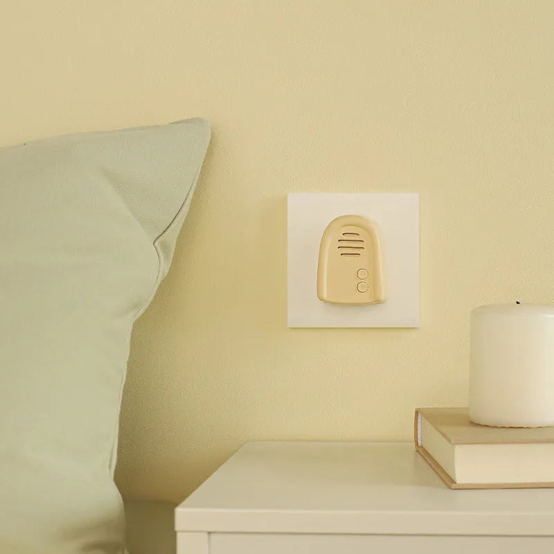 Wireless plug-in doorbell in milky yellow colour with compact design for household use