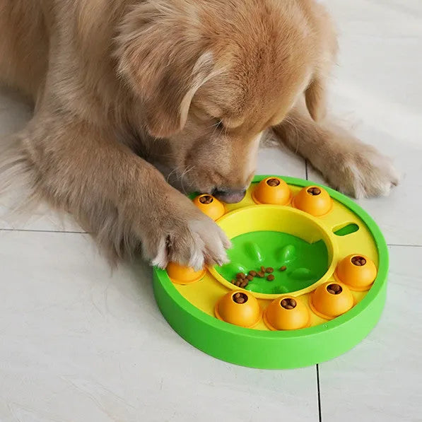 Square green interactive dog puzzle feeder bowl with central column and top turntable on a non-slip base.