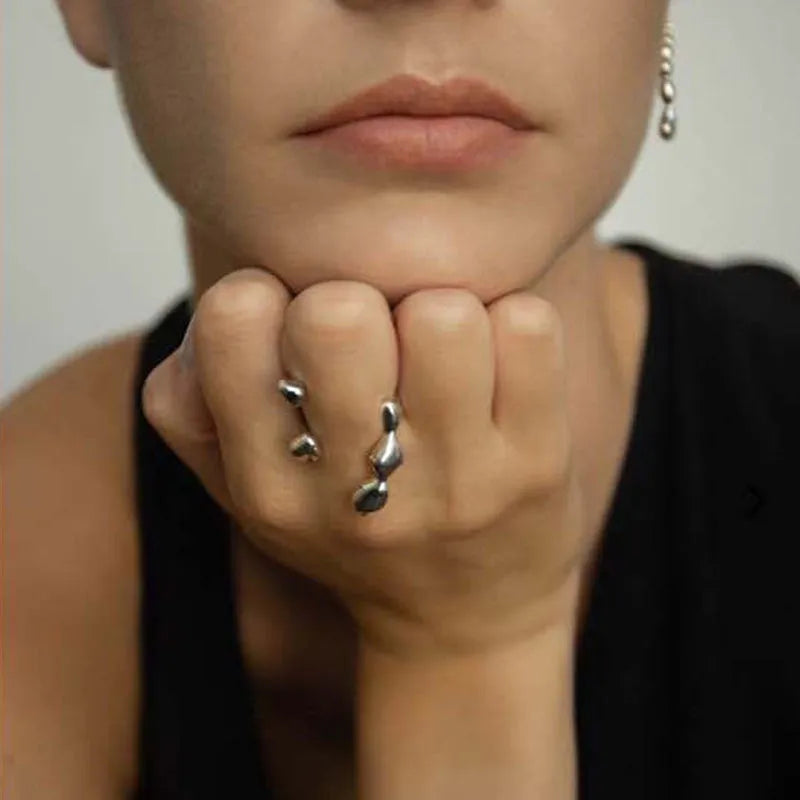 Adjustable brass fashion ring with spherical design in gold finish on hand