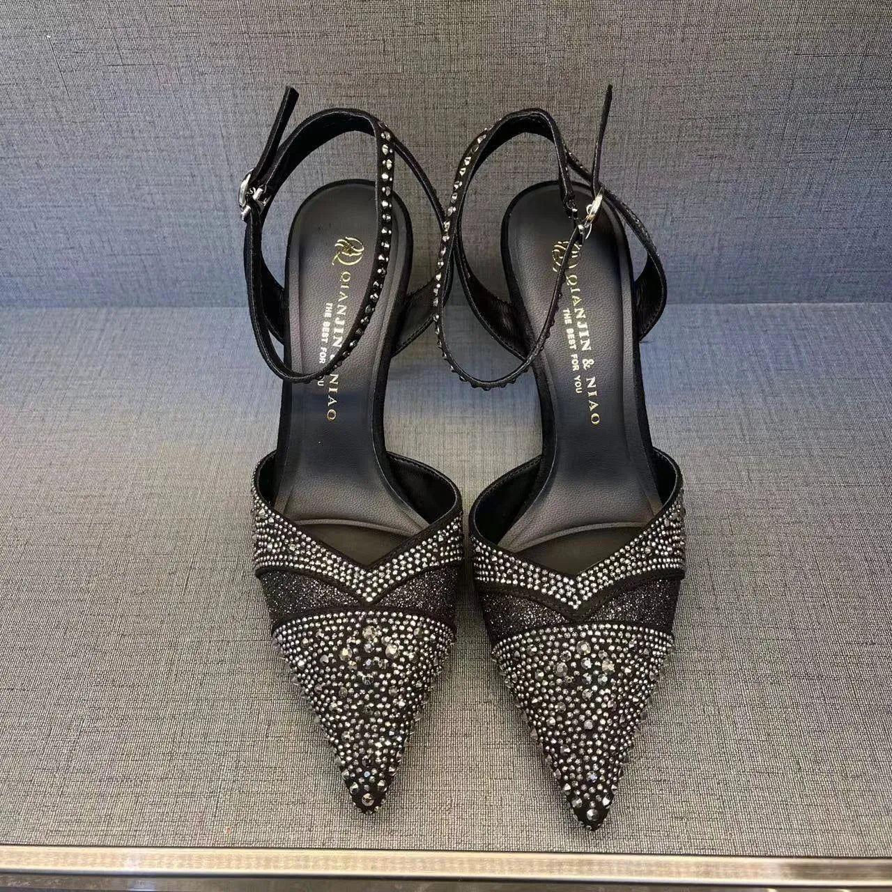 Women's hollow high heels with stiletto heel, pointed toe, and red sole in silver and black colours
