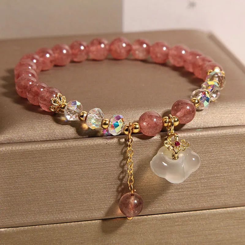 Women's strawberry quartz and white agate crystal bracelet with auspicious clouds charm.