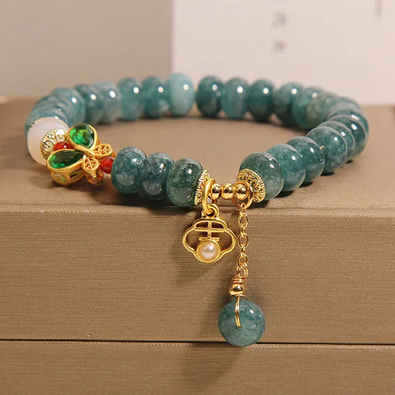 Women's blue water jade abacus bead crystal bracelet with butterfly charm and white agate accents
