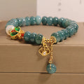 Women's blue water jade abacus bead crystal bracelet with butterfly charm and white agate accents