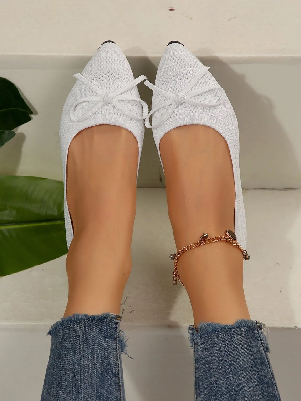 Women's knitted bow loafers with pointed-toe design in multiple colour options showing flat heel and rubber sole