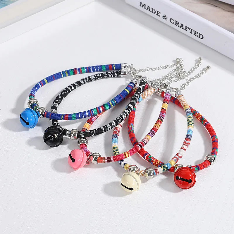 Adjustable dog collar with ethnic patterns and bell in black, blue, pink, red, or white colours, sizes S and L