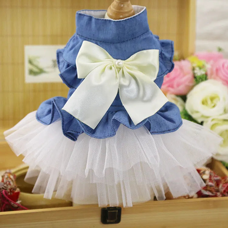 Korean-style denim dog skirt with bow detail in white or pink yarn, shown on a model dog.