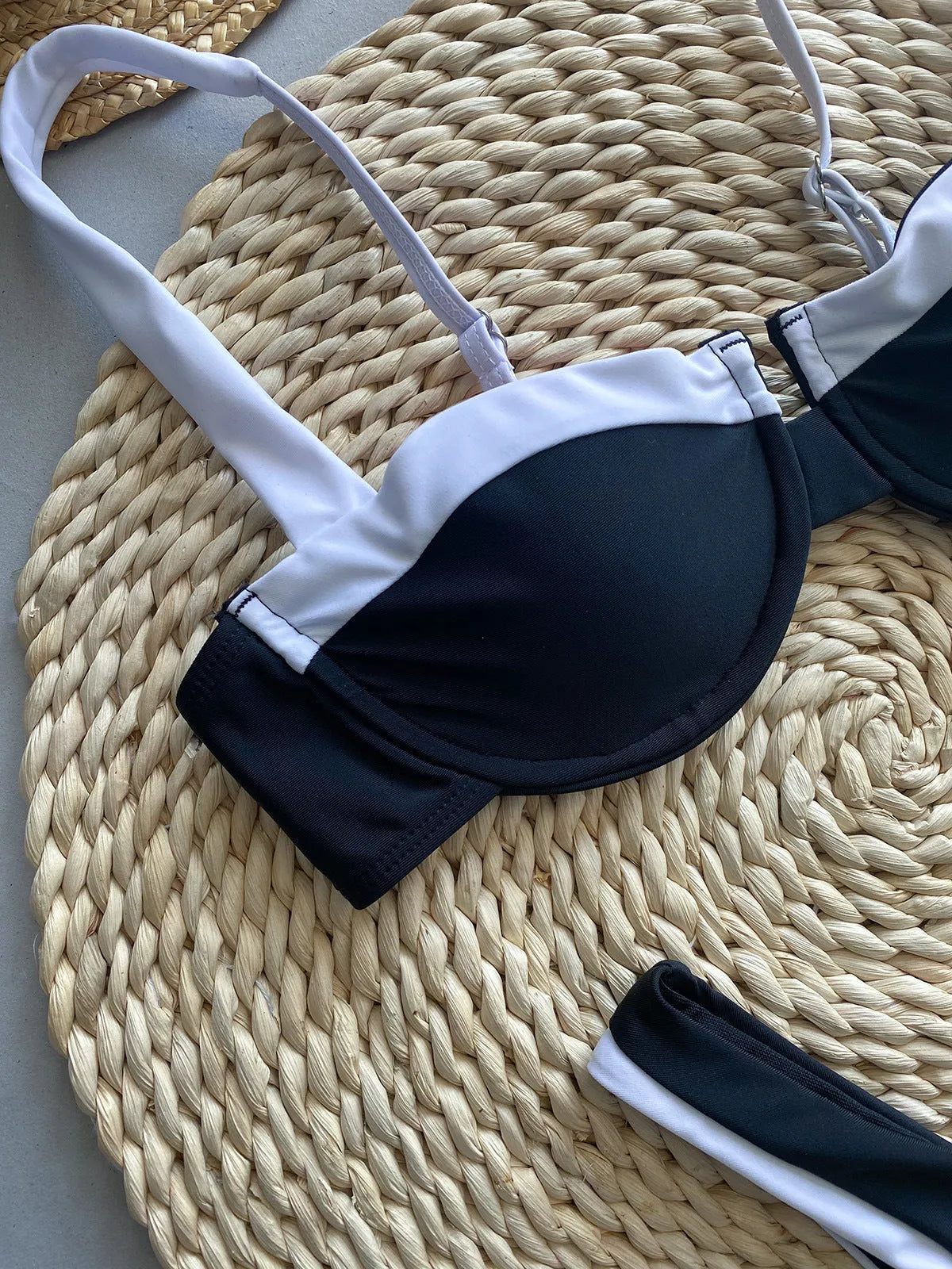 Black women's nylon bikini briefs set on a mannequin, showing front and back.
