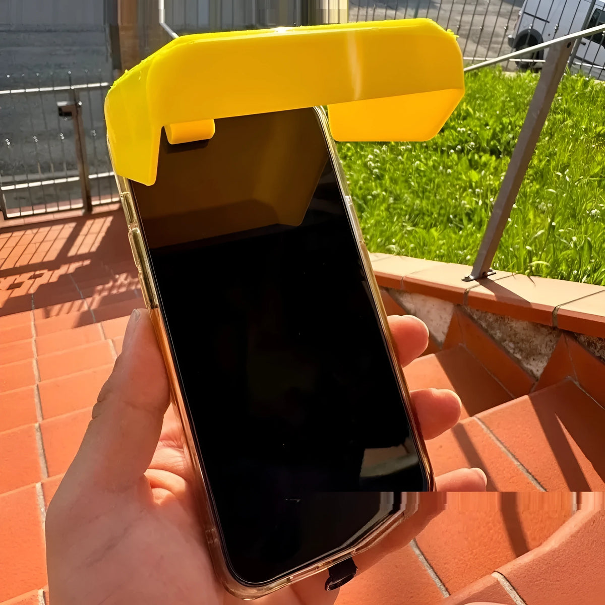 Yellow plastic beach pool phone sunshade holder clipped to mobile device