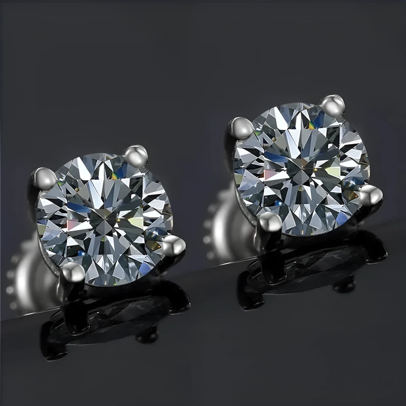 Close-up of a women's silver screw back moissanite stud earring with a four claw setting and geometric cut stone.