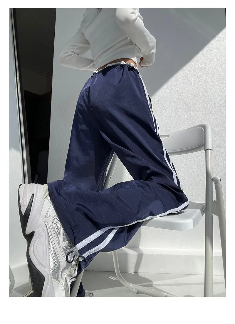 Women's loose straight-leg trousers with ribbon contrast detail in white and navy blue.